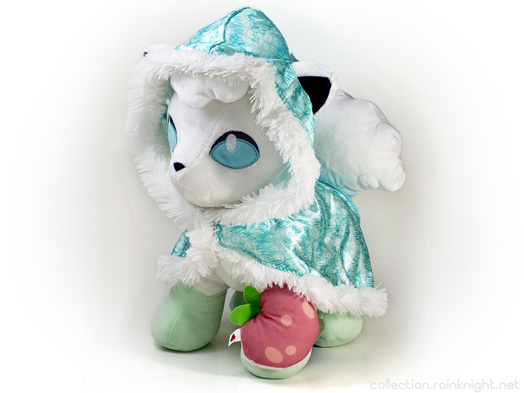 Build-A-Bear Alolan Vulpix. It's a white Vulpix with blue eyes and is wearing a blue cape with a white furry lining. It's holding a berry that looks like a peach.